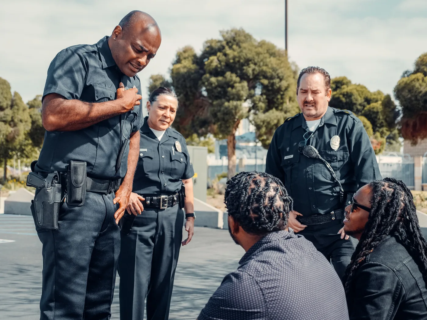 Patrol officers speaking with community members during a street-level field contact